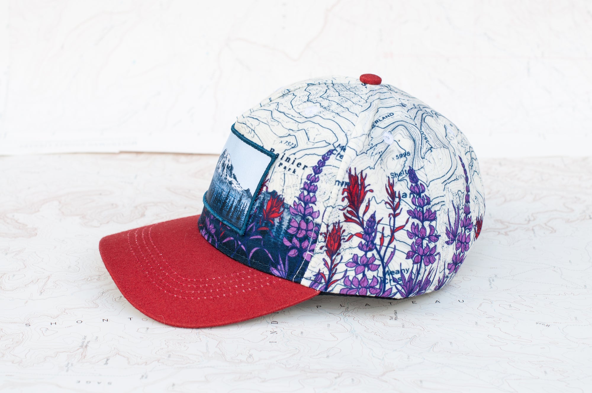 side view of the final switchback twill hat featuring artist Katie Jeanne Reim's Mount Rainier Meadow print