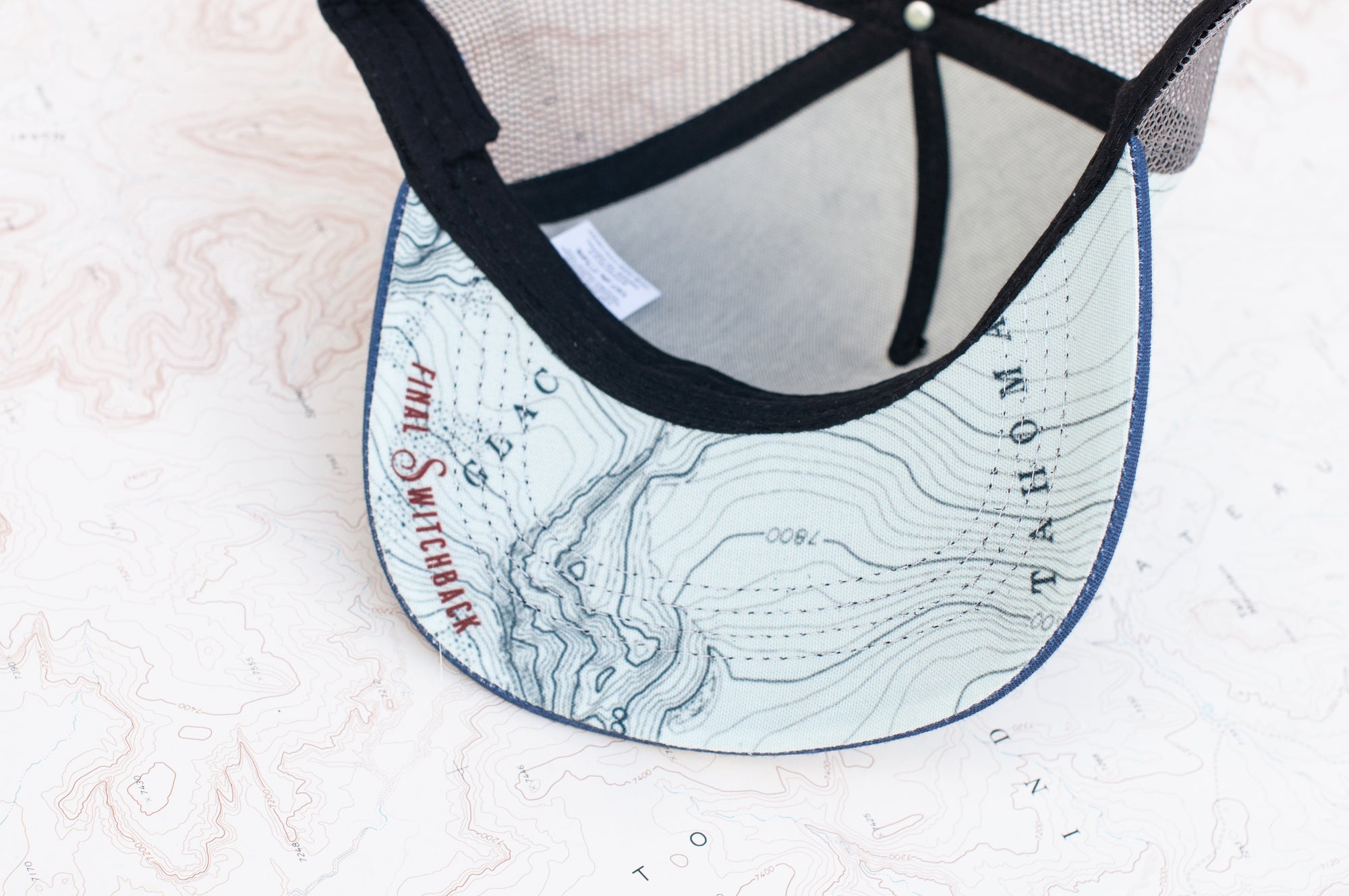 Brim view of the final switchback trucker hat featuring artist Katie Jeanne Reim&#39;s Mount Rainier Summit print