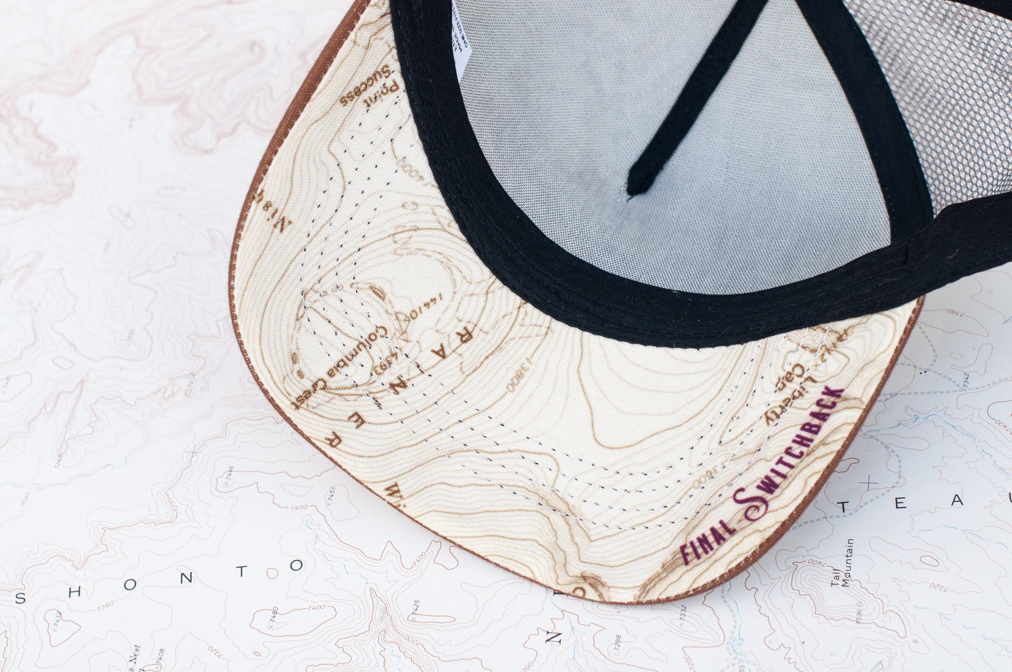 brim view of the final switchback trucker hat featuring artist Katie Jeanne Reim&#39;s Mount Rainier Sunset print