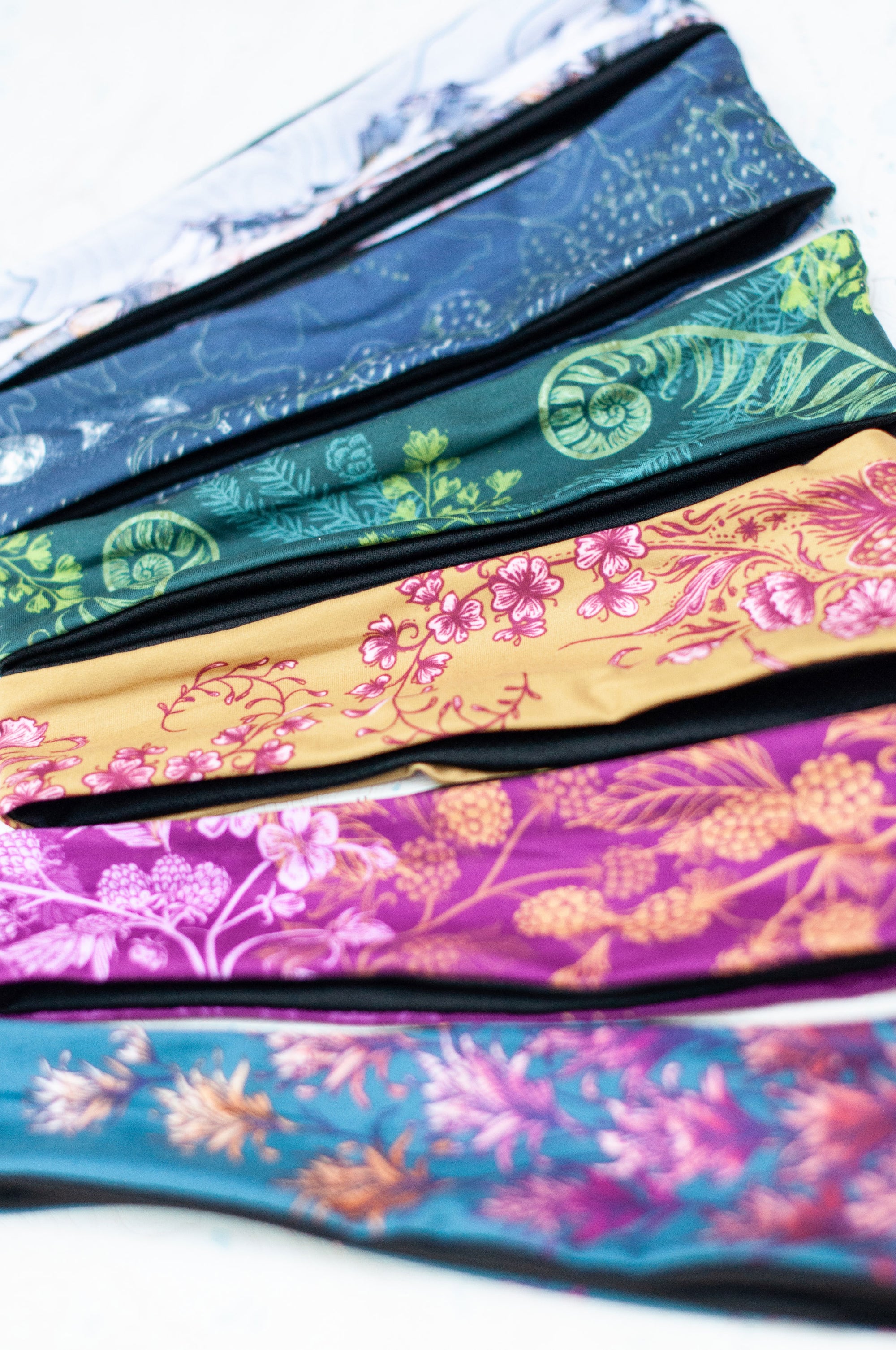 a variety of final switchback headbands printed with Katie's nature art prints