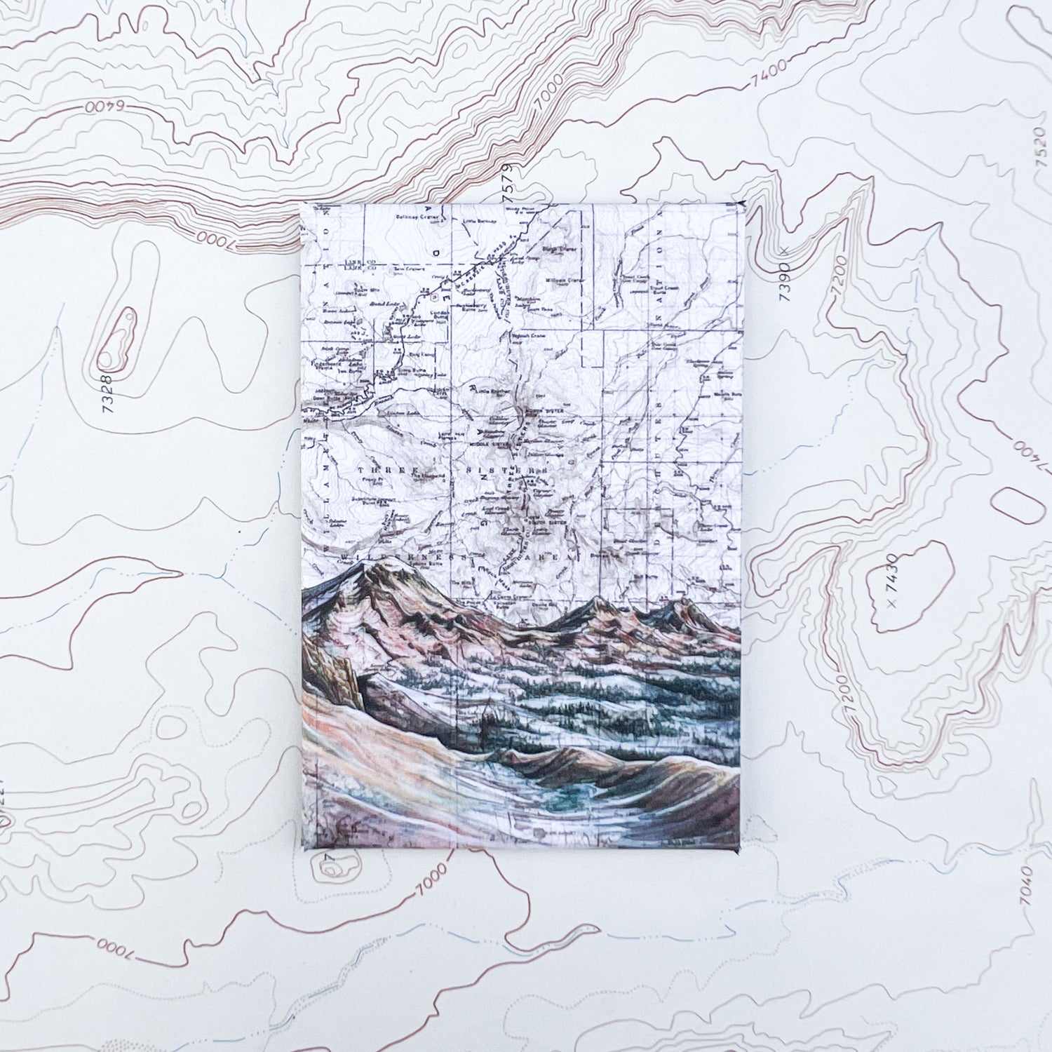 a final switchback button magnet featuring Katie Jeanne Reim's three sisters alpenglow print