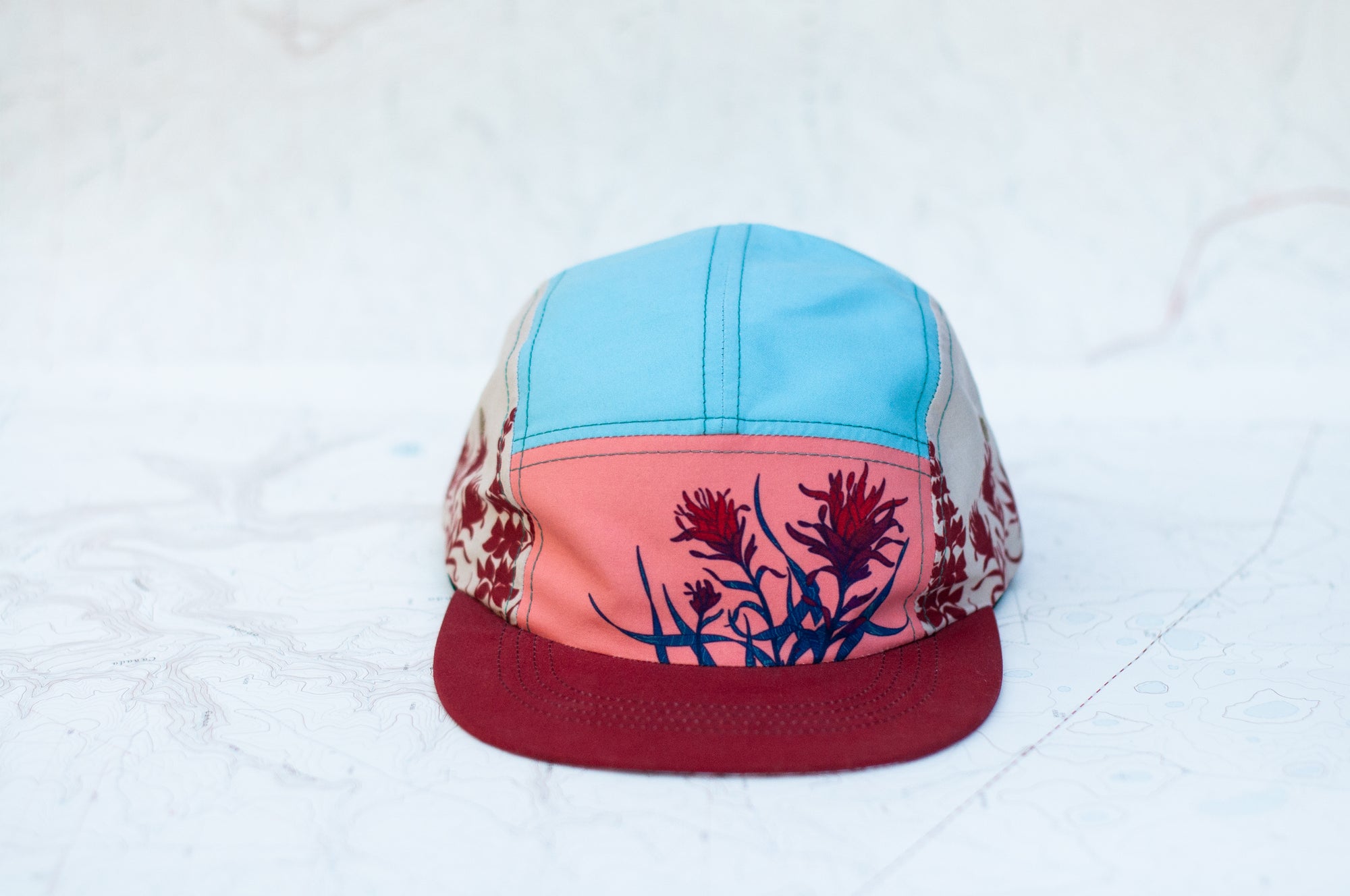 front view of the final switchback 5-panel trail hat featuring artist Katie Jeanne Reim&#39;s Paintbrush print