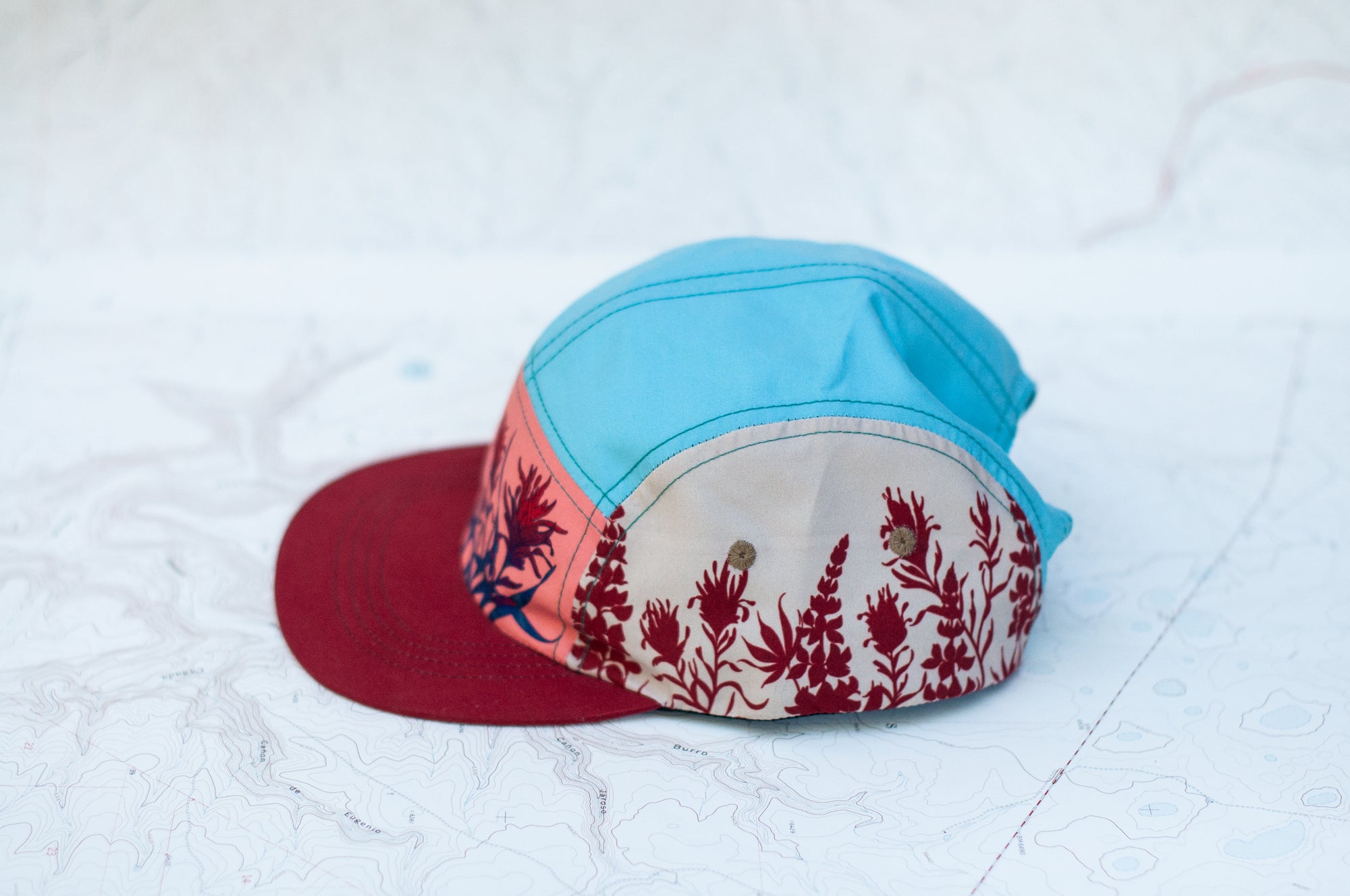 side view of the final switchback 5-panel trail hat featuring artist Katie Jeanne Reim&#39;s Paintbrush print