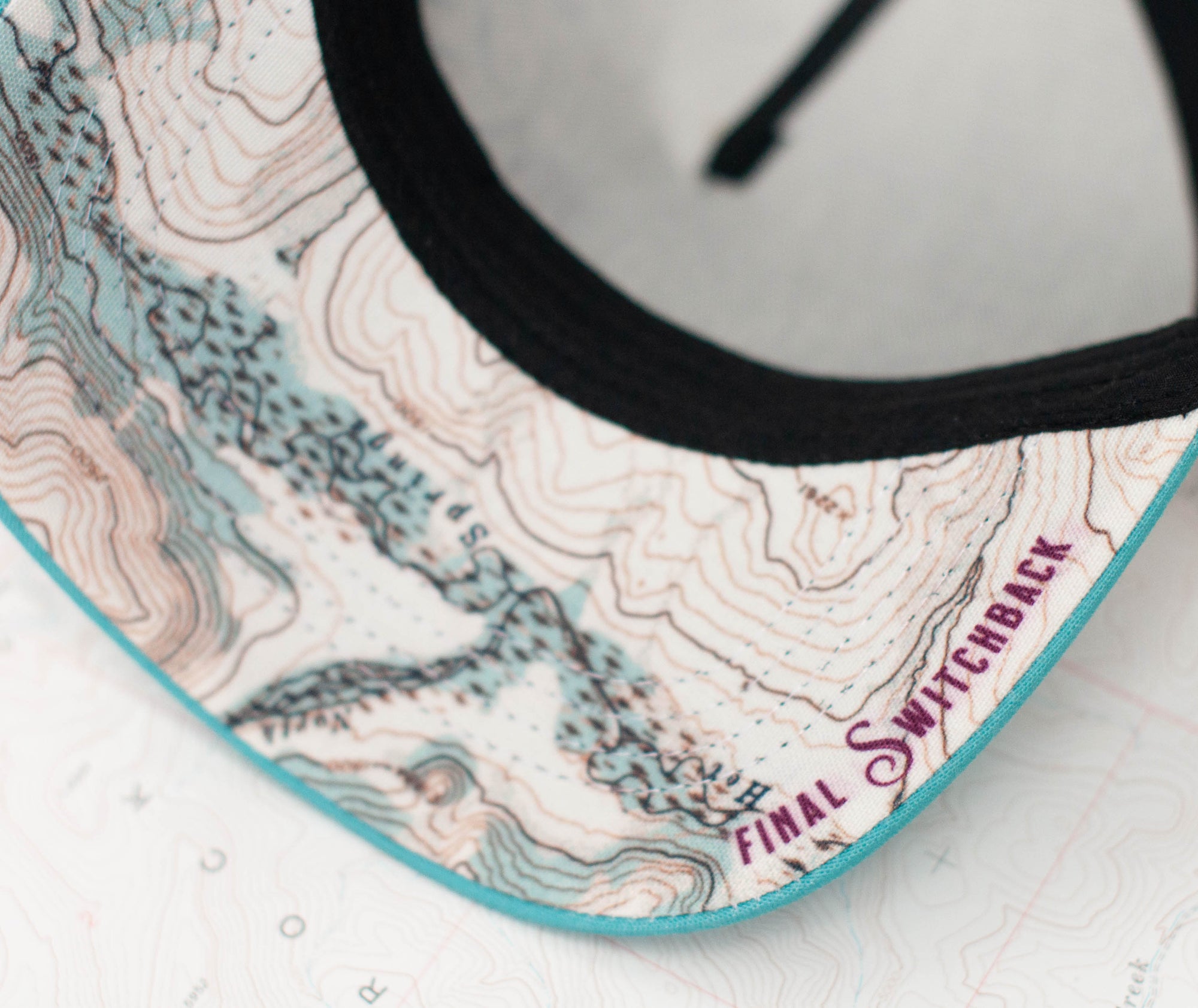 brim view of the final switchback trucker hat featuring artist Katie Jeanne Reim&#39;s teton print
