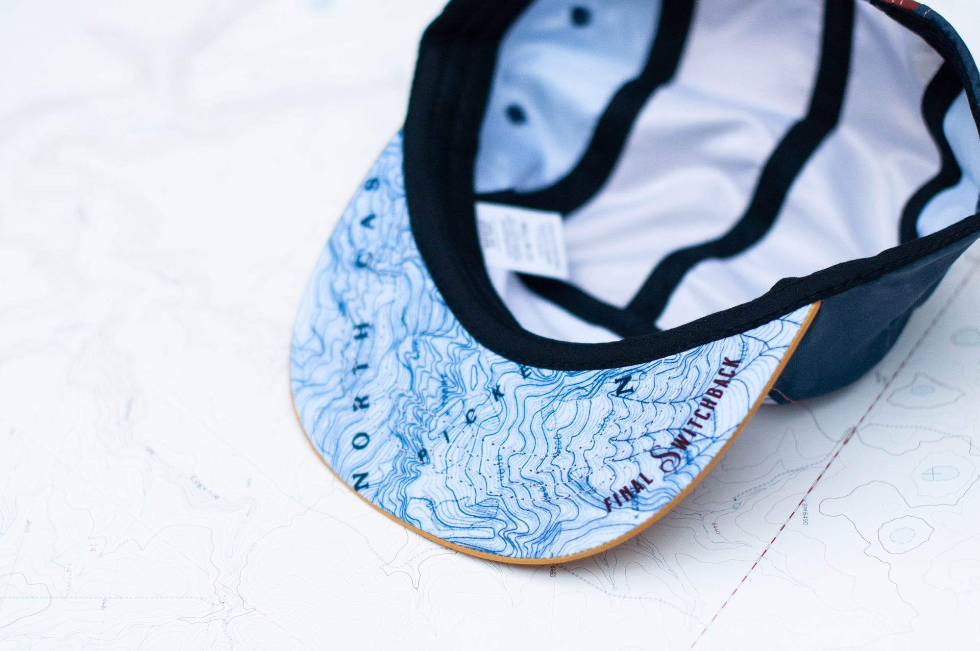 brim view of the final switchback 5-panel trail hat featuring artist Katie Jeanne Reim&#39;s Picket Range print
