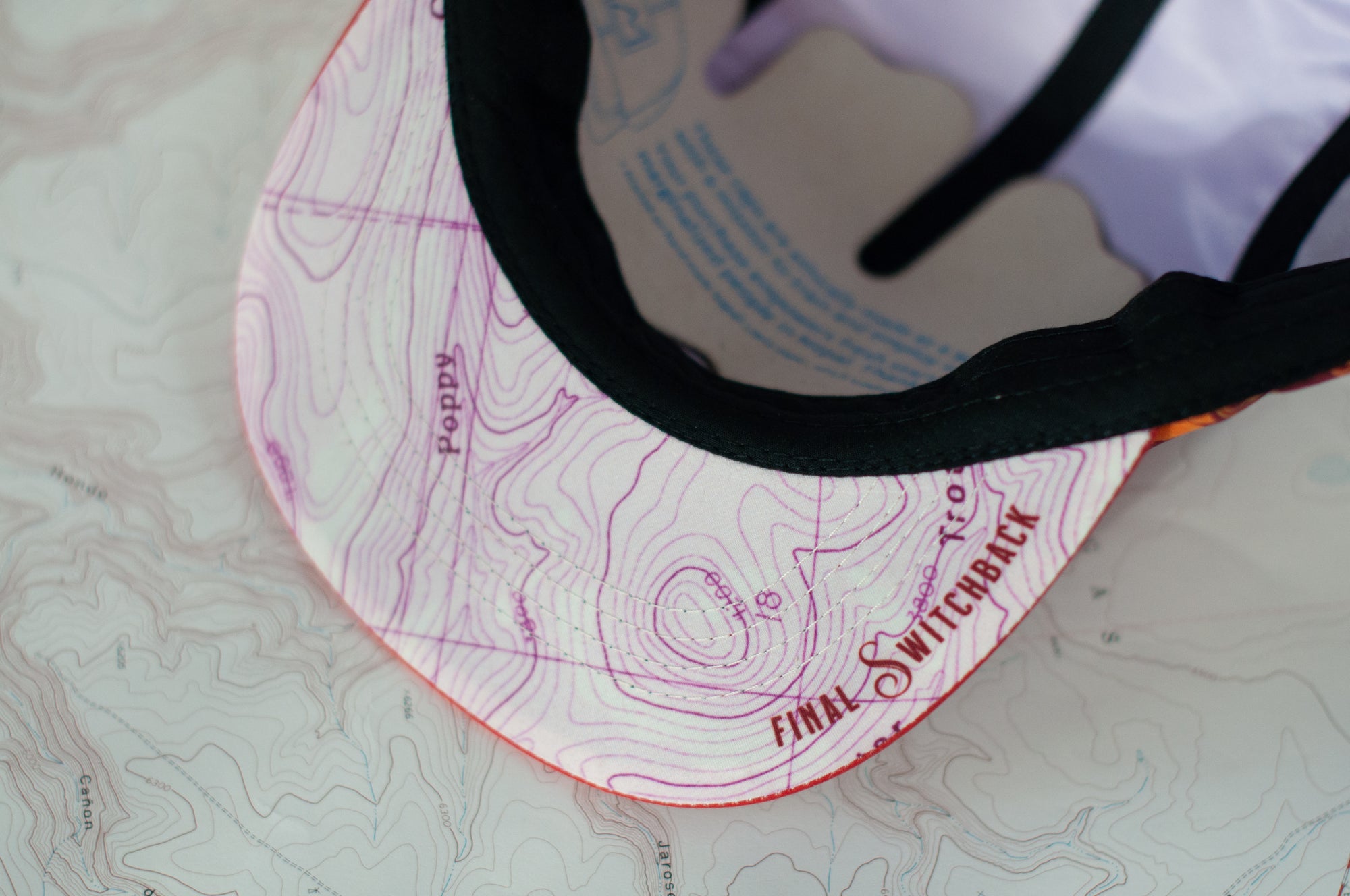 brim view of the final switchback 5-panel trail hat featuring artist Katie Jeanne Reim&#39;s Poppy print