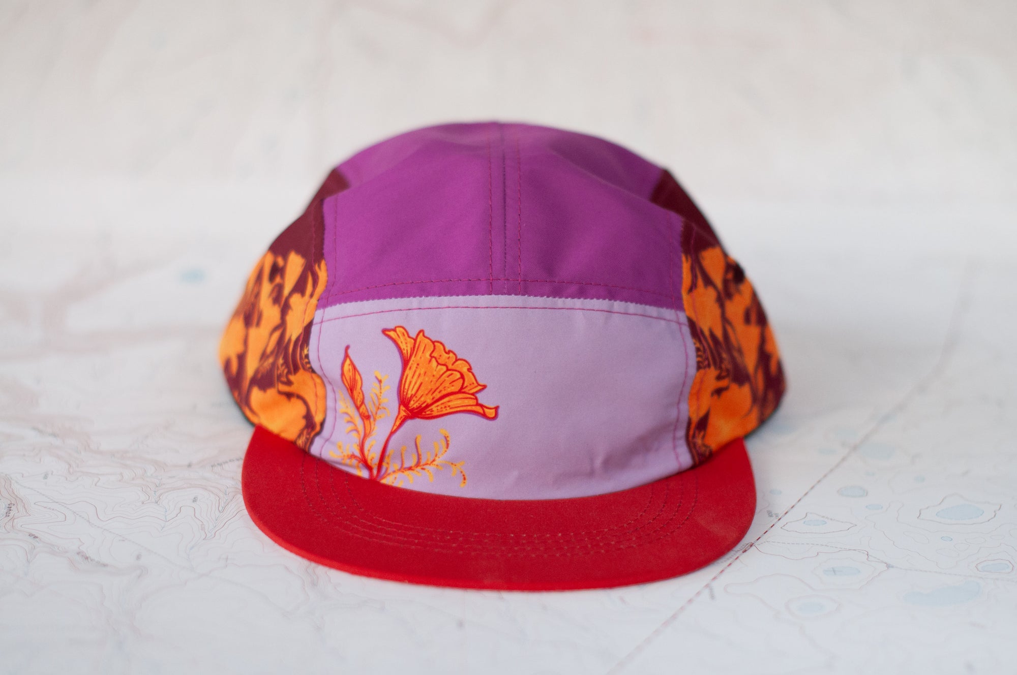 front view of the final switchback 5-panel trail hat featuring artist Katie Jeanne Reim&#39;s Poppy print