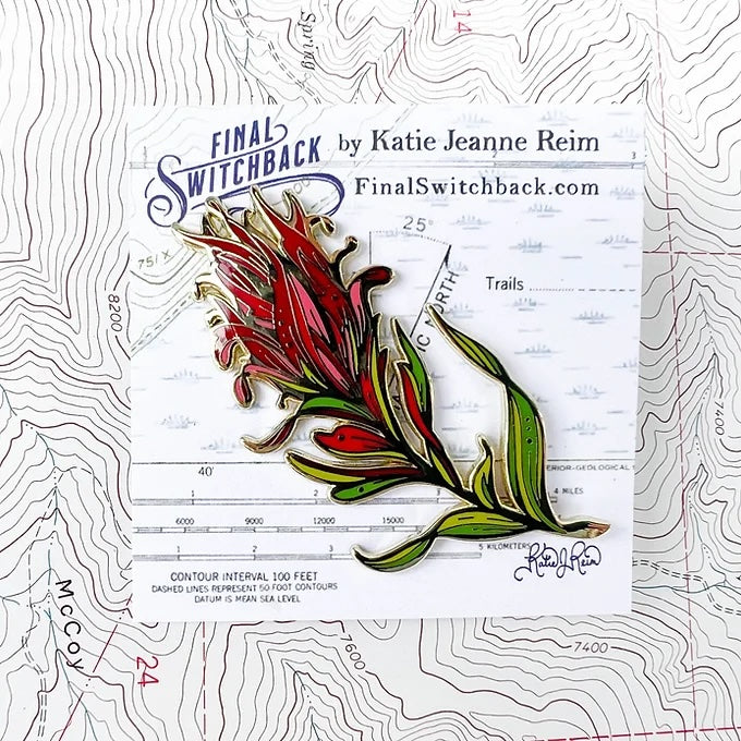 final switchback red paintbrush enamel pin on holder created by artist Katie Jeanne Reim