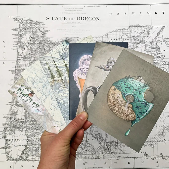 a hand holding final switchback&#39;s greeting cards featuring taste of Portland prints by artist Katie Jeanne Reim