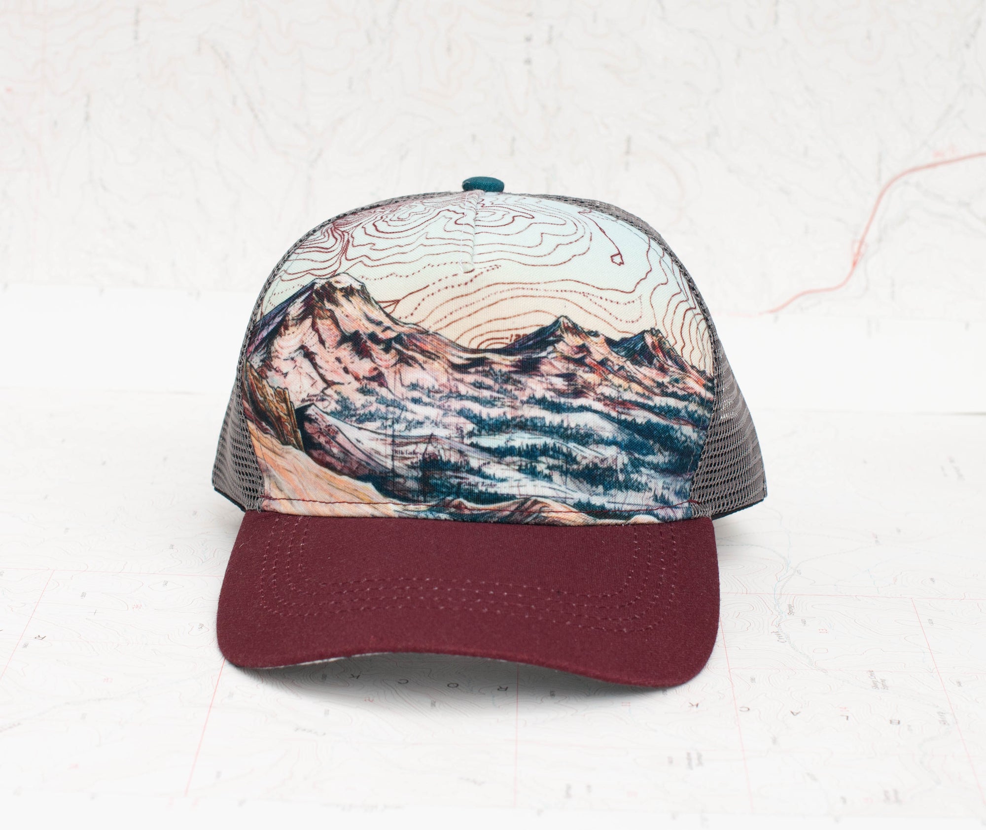 front view of the final switchback trucker hat featuring artist Katie Jeanne Reim&#39;s three sisters print