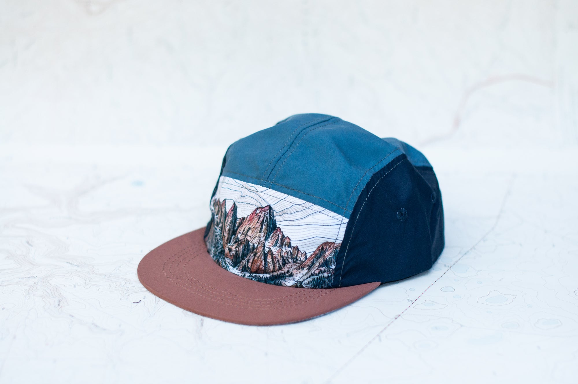 side angle view of the final switchback 5-panel trail hat featuring artist Katie Jeanne Reim's Whitney print