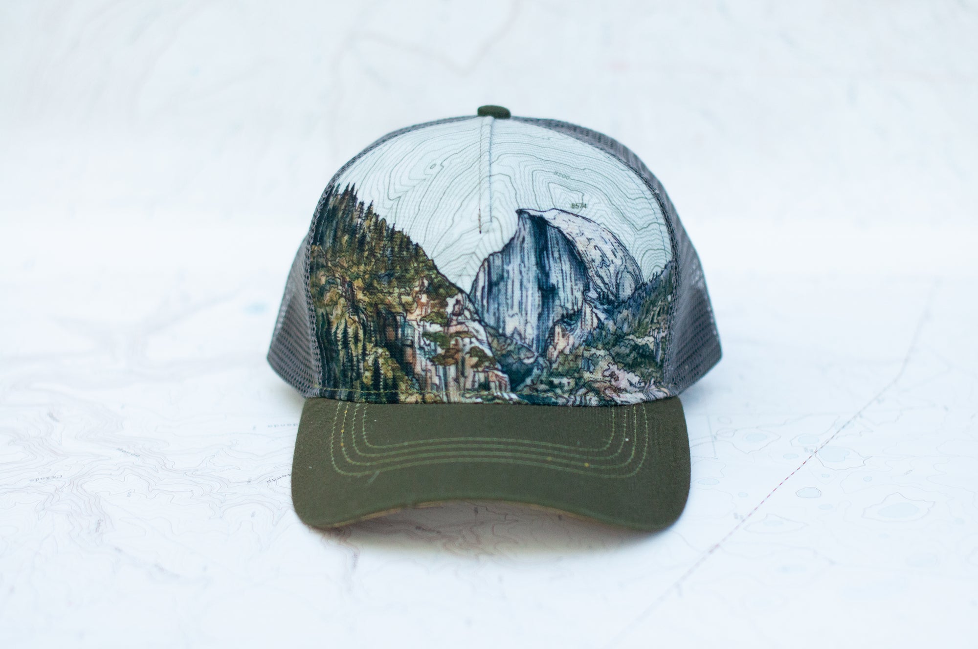 front view of the final switchback trucker hat featuring artist Katie Jeanne Reim&#39;s Yosemite print