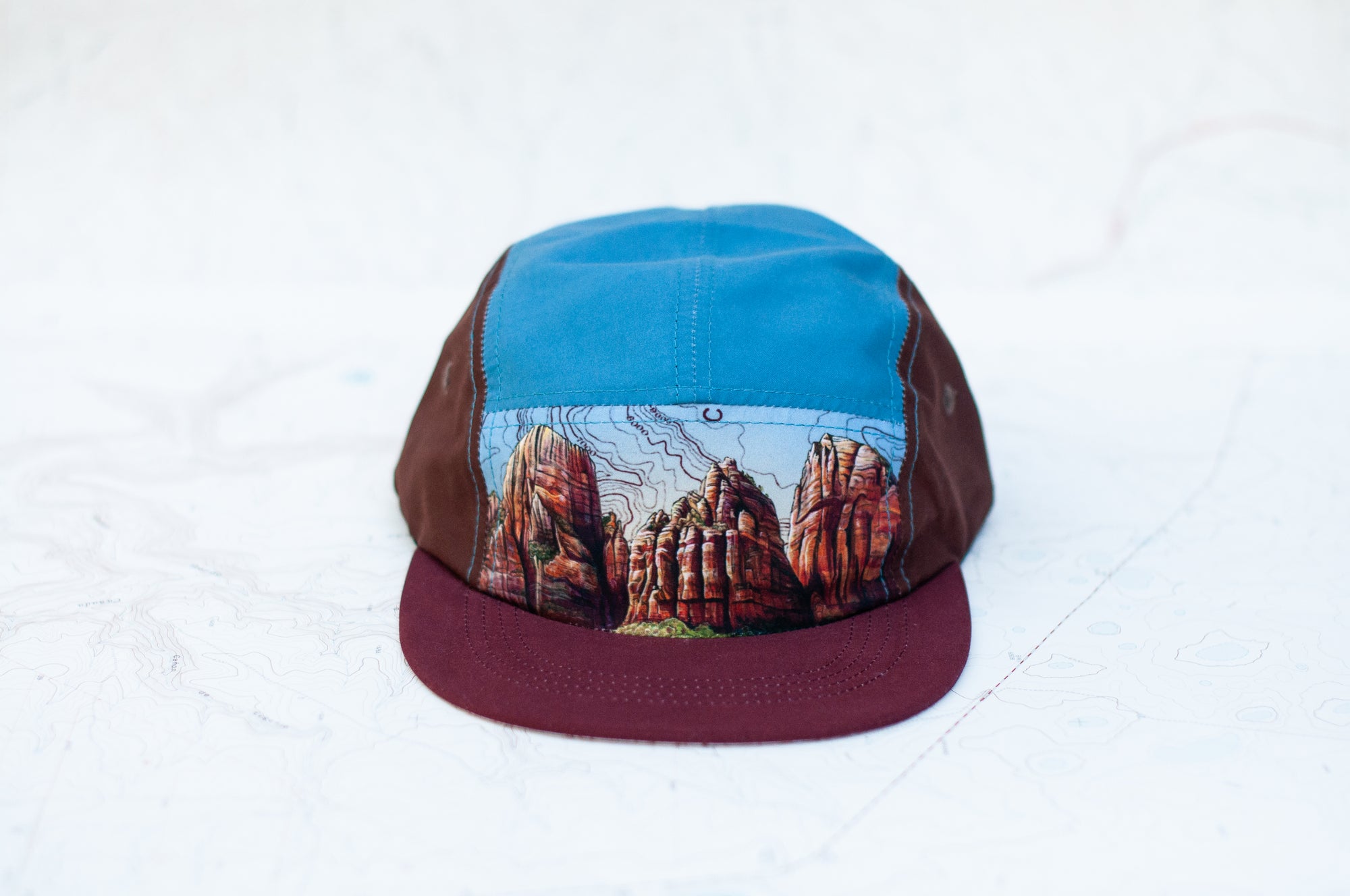 Front view of the final switchback 5-panel trail hat featuring artist Katie Jeanne Reim&#39;s Zion print