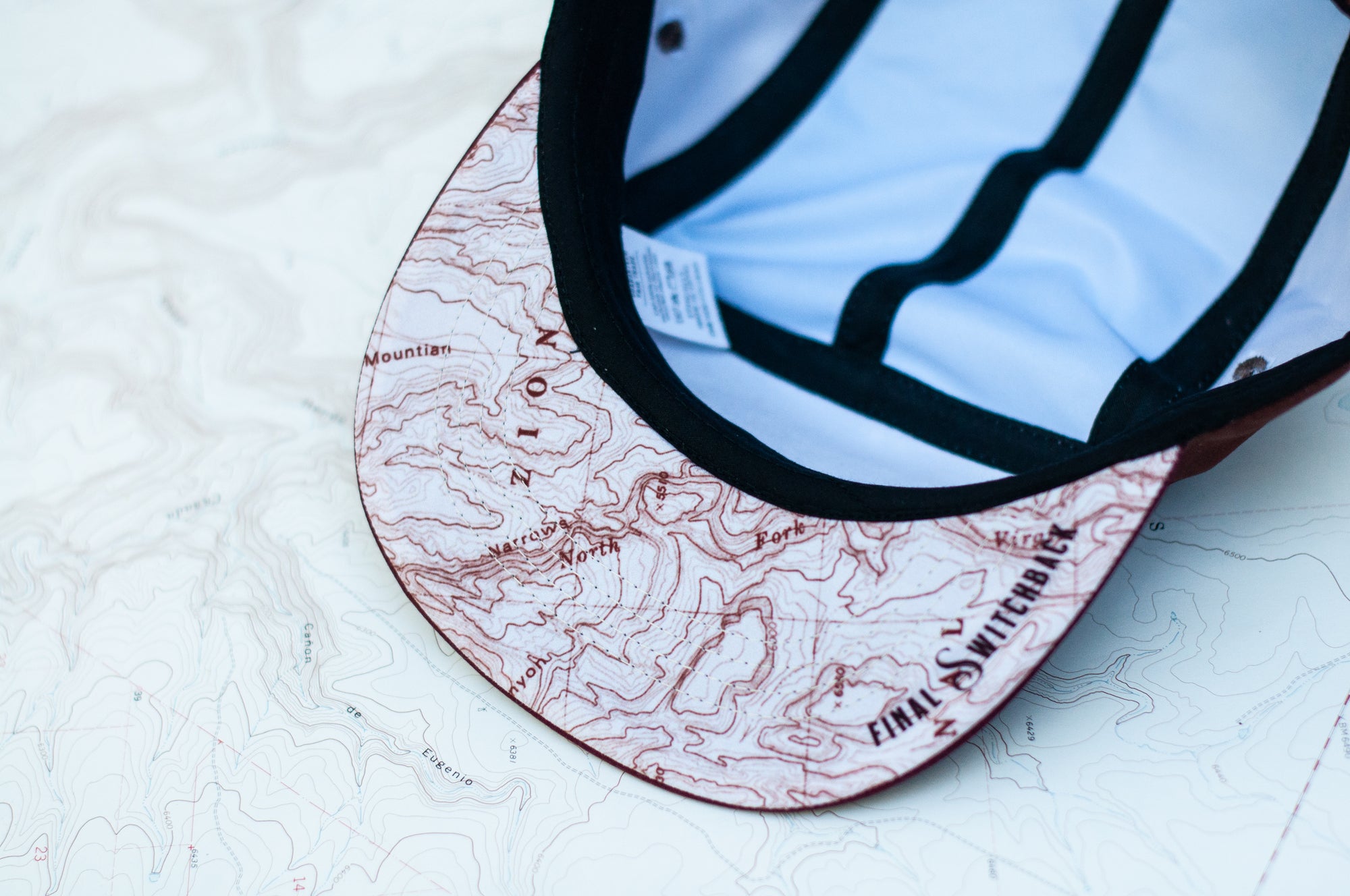 Brim view of the final switchback trucker hat featuring artist Katie Jeanne Reim&#39;s Zion print